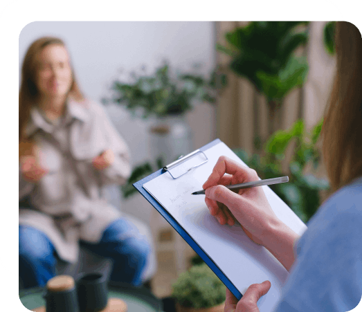 Eating disorder therapist talking to a woman in a counselling session.