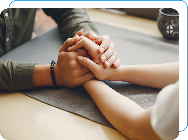 Two people holding hands after affair counselling.