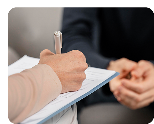 Therapist writing notes on a sheet.