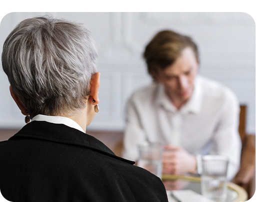 A therapist talking to a man in an anxiety counselling session.