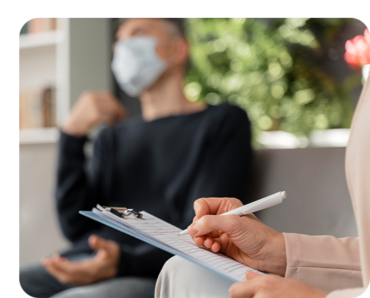 An anxiety psychologist writing notes in an anxiety counselling session.