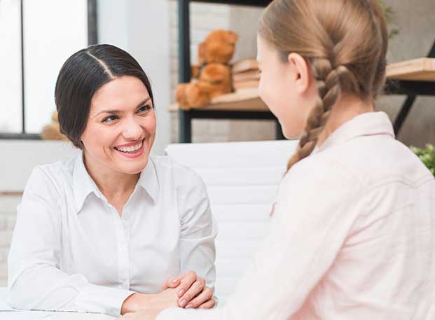Young girl talking to a therapist in counselling for depression.
