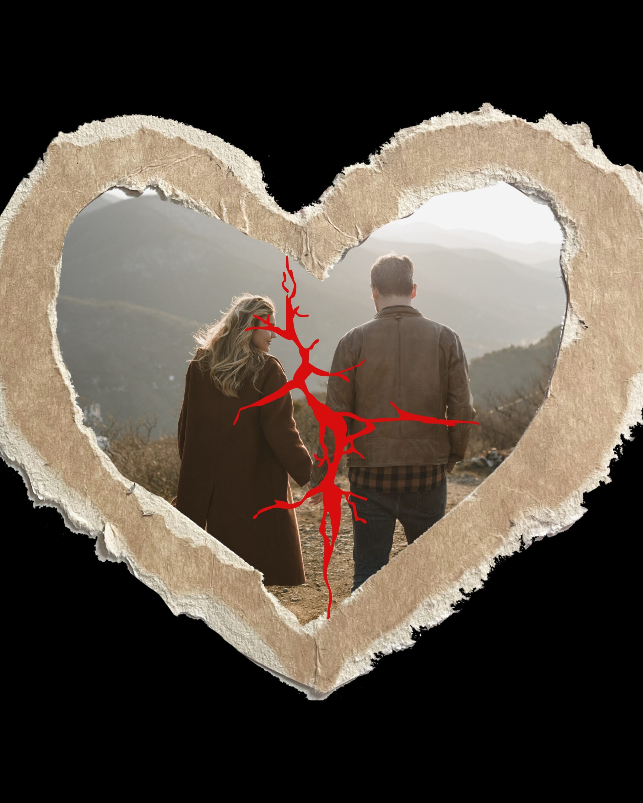 Couple seen through a torn paper heart